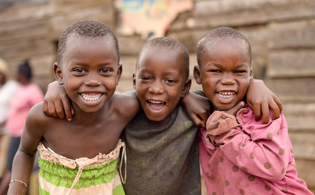 Children Holding each other while smiling